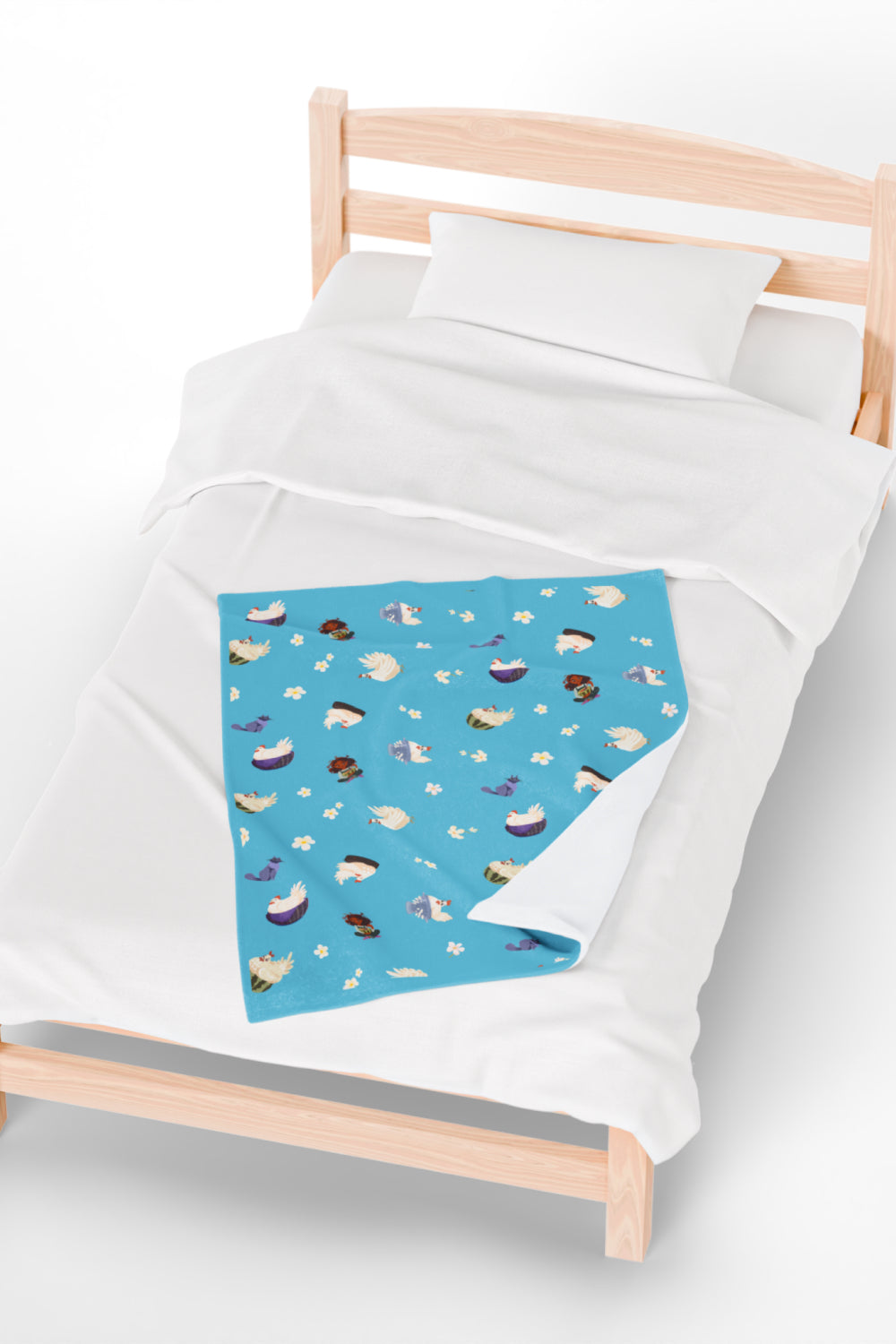 Patterned childrens velveteen blanket with chicken, cat, and little girl cartoon characters and flowers on a blue background