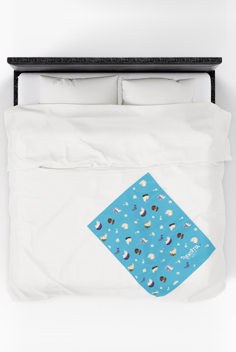 Patterned childrens velveteen blanket with chicken, cat, and little girl cartoon characters and flowers on a blue background