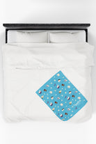 Patterned childrens velveteen blanket with chicken, cat, and little girl cartoon characters and flowers on a blue background