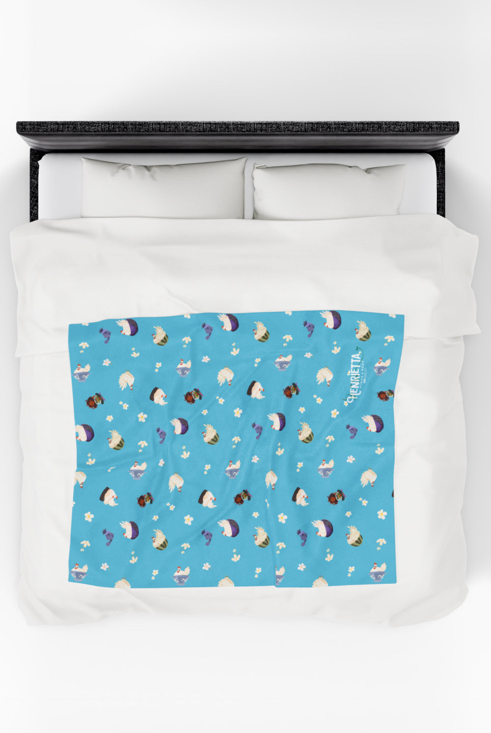 Patterned childrens velveteen blanket with chicken, cat, and little girl cartoon characters and flowers on a blue background