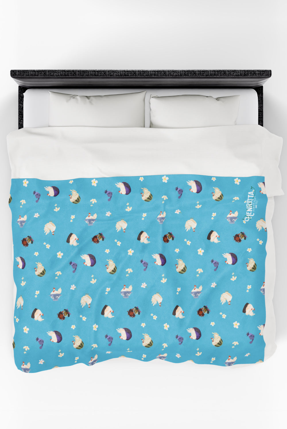 Patterned childrens velveteen blanket with chicken, cat, and little girl cartoon characters and flowers on a blue background